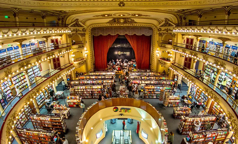 Livrarias da Avenida Corrientes Interior de uma livraria na Avenida Corrientes, com prateleiras cheias de livros.